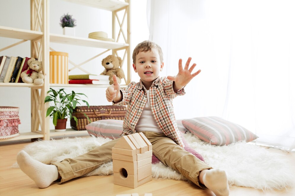 Petit garçon sur un tapis jouant avec son cube en bois